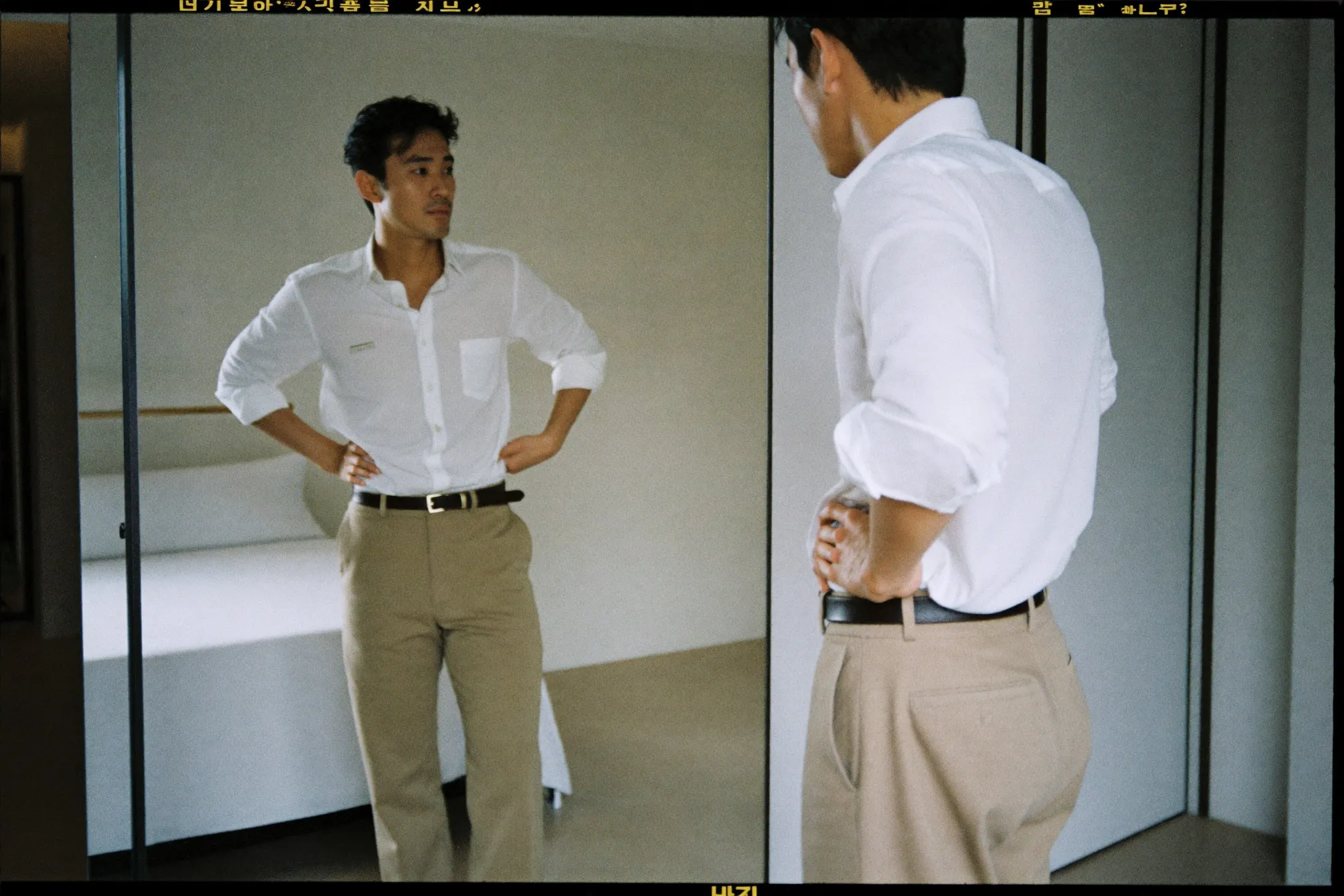 Man checking his outfit in a full-length mirror