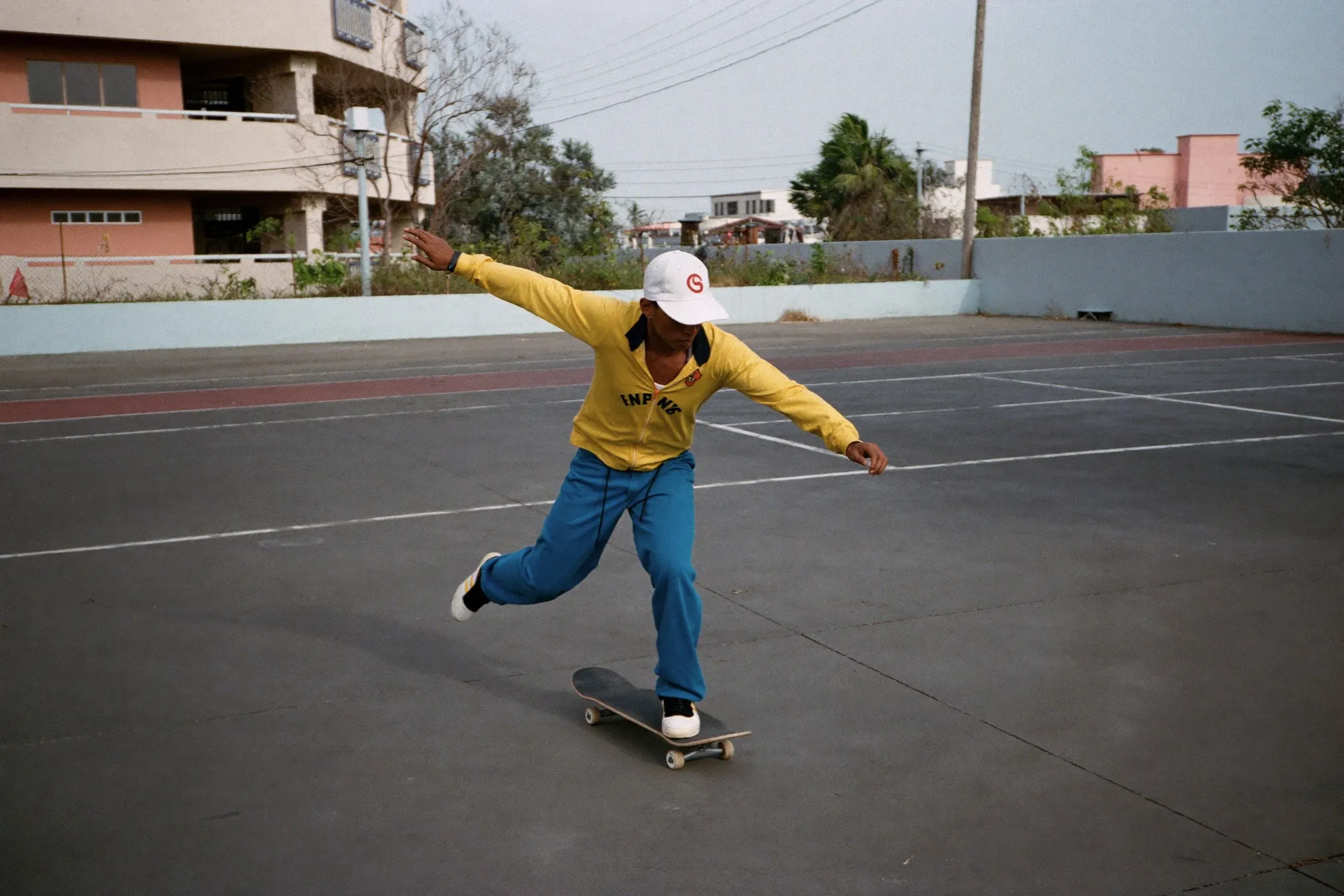 Malay man doing low-impact lateral skater steps at an empty HDB void deck in Singapore early in the morning