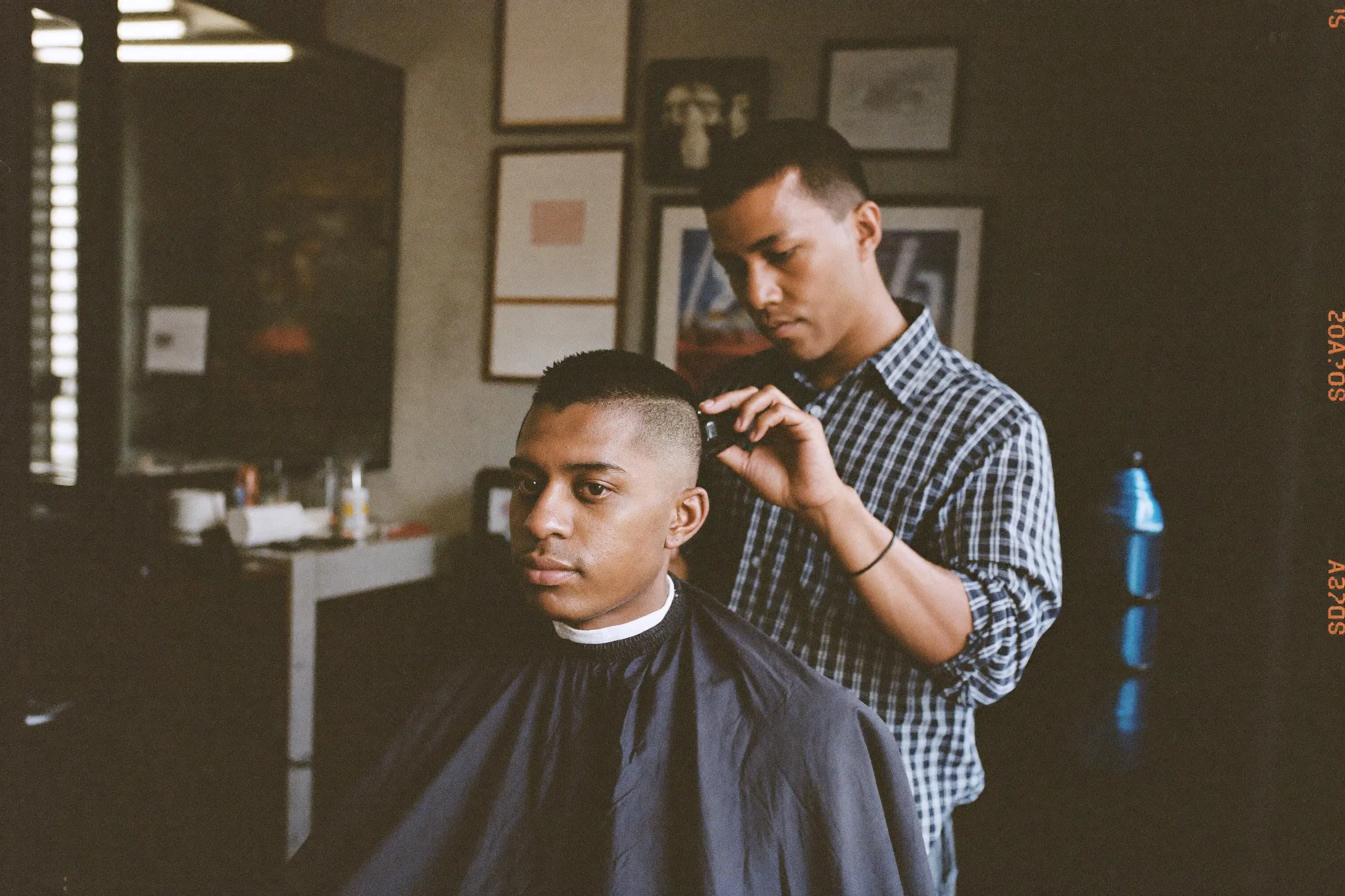 Man getting a sharp haircut in a modern barbershop