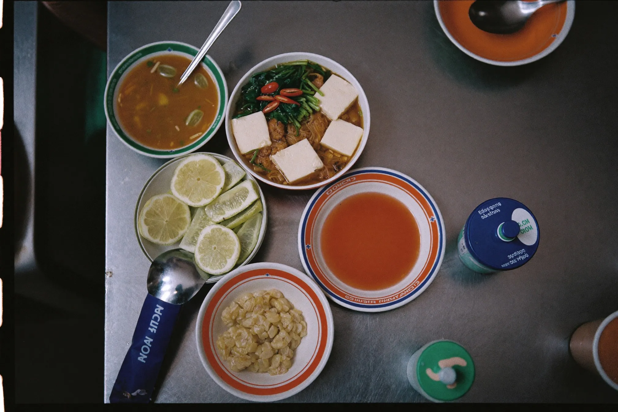Overhead view of a yong tau foo bowl with tofu, fishcake and vegetables on a hawker centre table