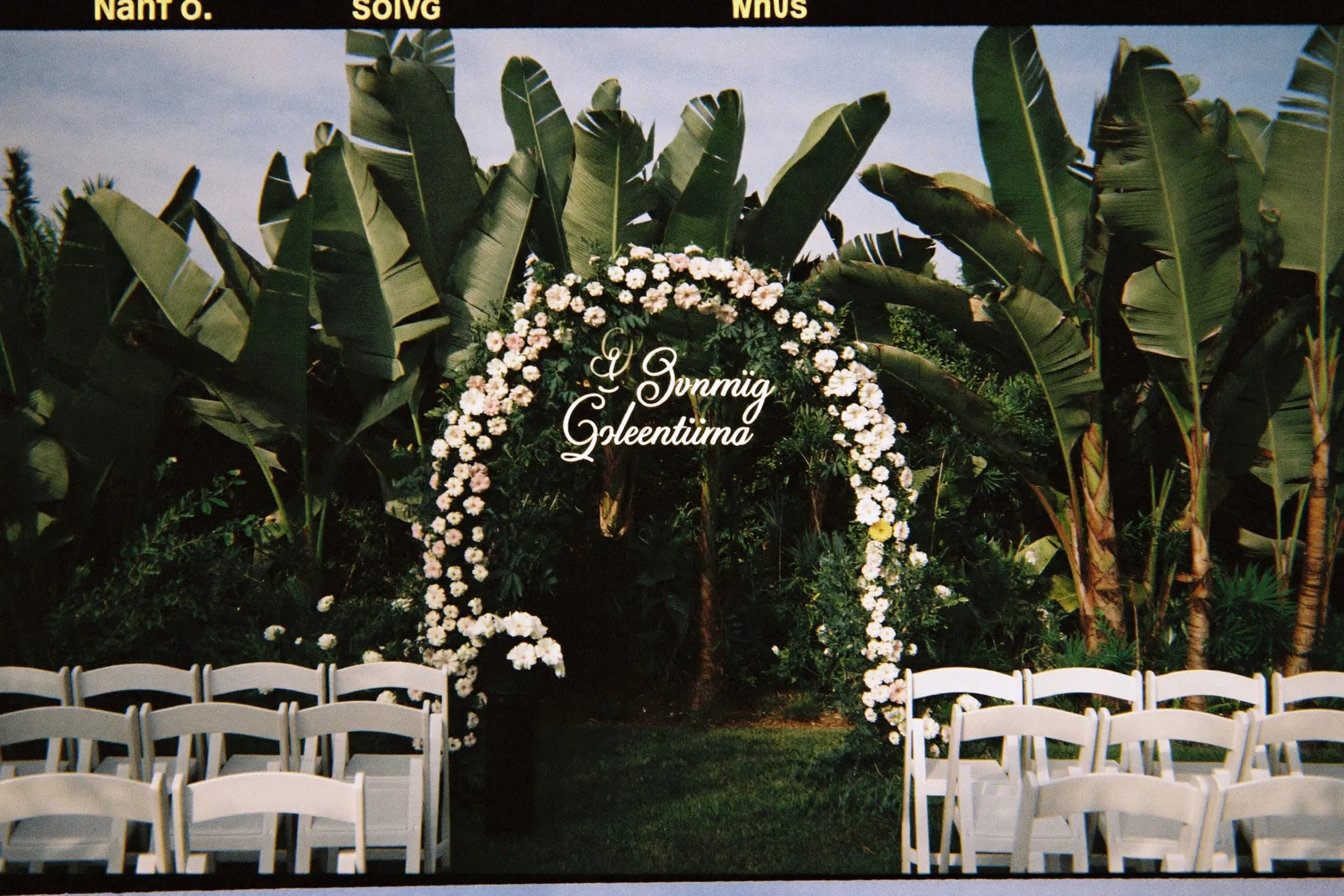 Garden solemnisation arch with white flowers and rows of chairs